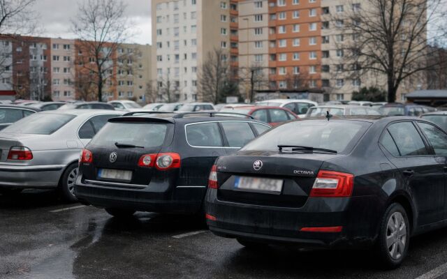 Parkovisko s autami v Bratislave s viditeľnými cenovkami a nápismi