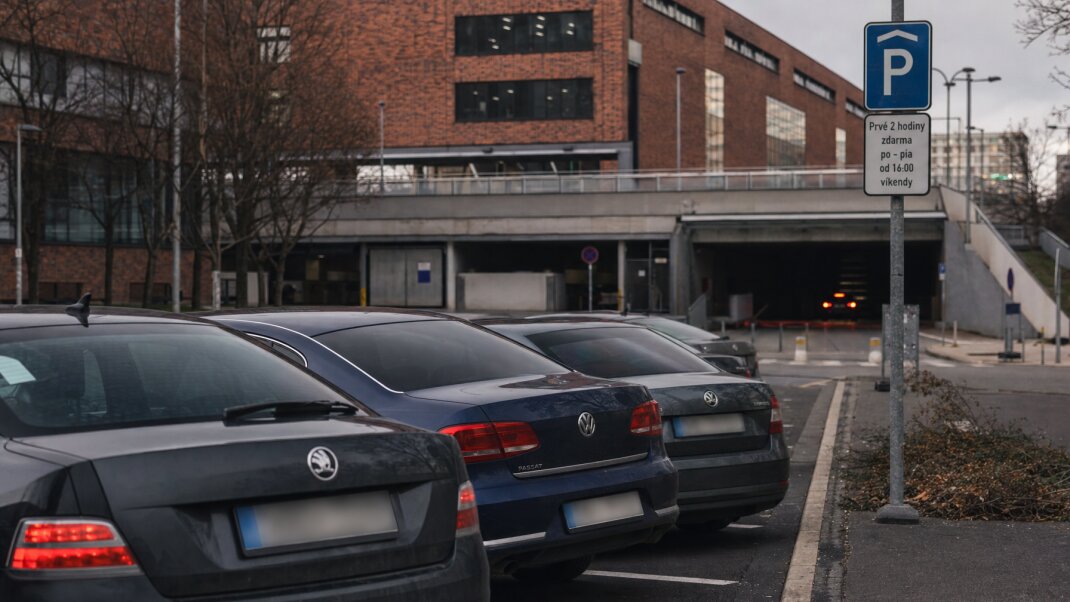 Parkovisko na Nivách s autami a parkovacími automatmi